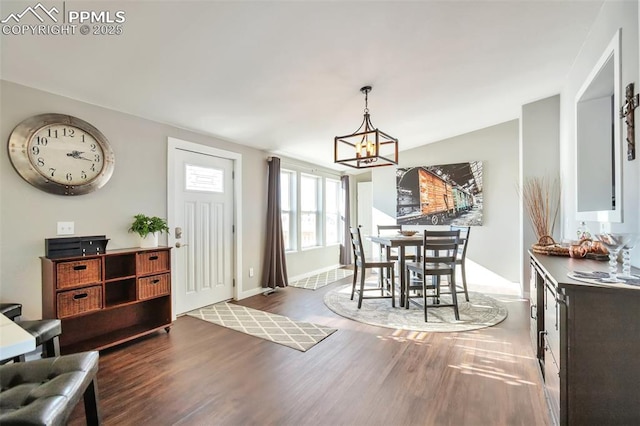 dining room with vaulted ceiling, dark wood-type flooring, and an inviting chandelier