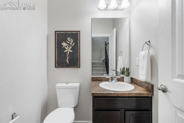 bathroom featuring toilet and vanity