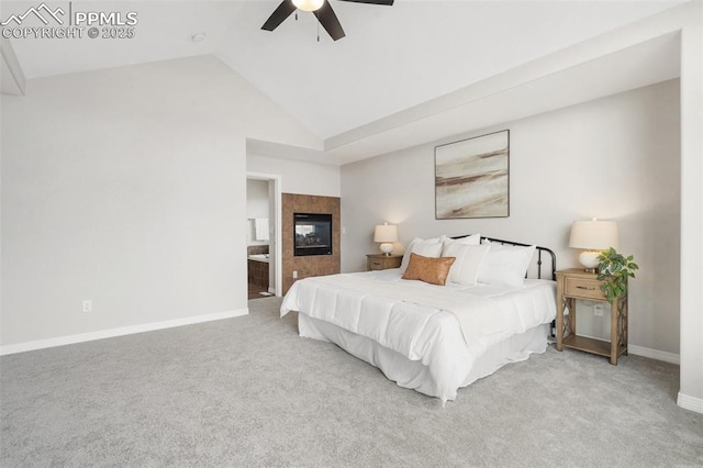 bedroom featuring ceiling fan, light colored carpet, a fireplace, connected bathroom, and lofted ceiling