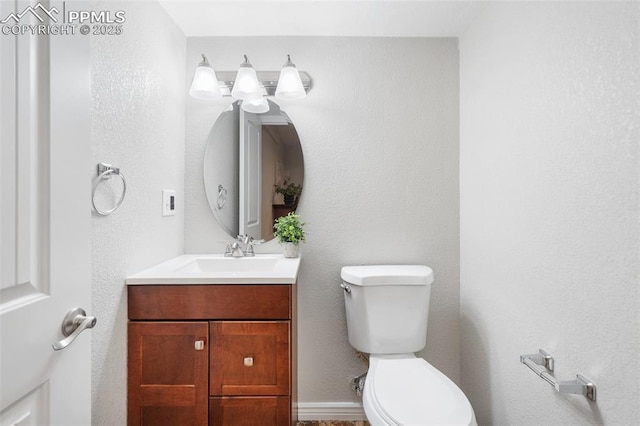 bathroom with toilet and vanity