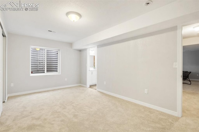 unfurnished room featuring light colored carpet