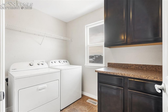 laundry area featuring cabinets and washer and dryer