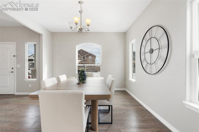 dining room featuring an inviting chandelier and dark hardwood / wood-style floors