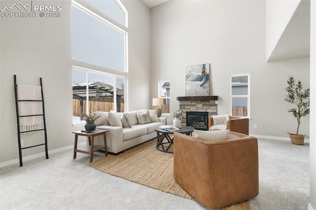 living room featuring a fireplace, a high ceiling, and carpet flooring