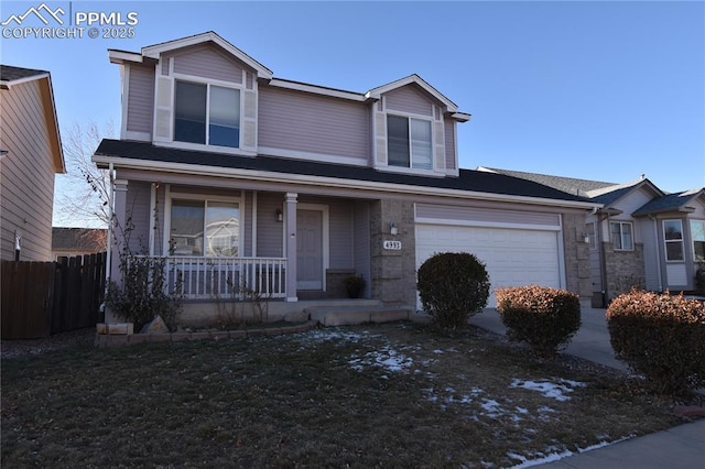 view of front of property with a garage and covered porch