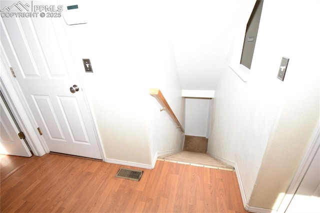 staircase featuring hardwood / wood-style floors