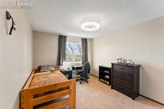 bedroom featuring a textured ceiling and light carpet