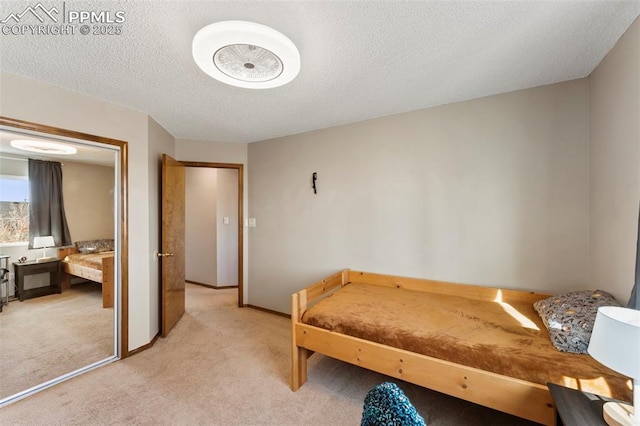 carpeted bedroom with a textured ceiling