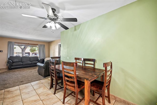 carpeted dining space featuring ceiling fan