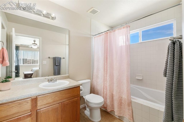 full bathroom featuring ceiling fan, toilet, shower / tub combo, vanity, and visible vents