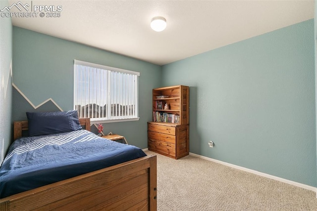 carpeted bedroom featuring baseboards