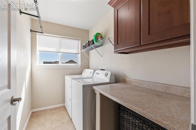 washroom featuring cabinet space, independent washer and dryer, and baseboards