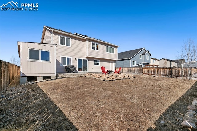 rear view of property featuring a patio area and a fenced backyard