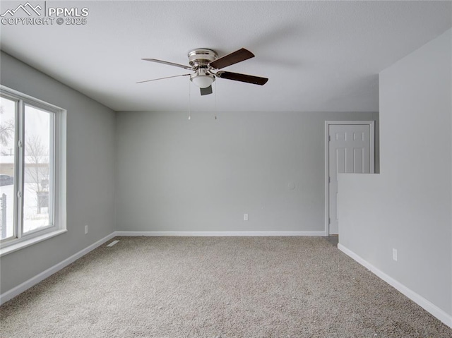 carpeted empty room featuring ceiling fan