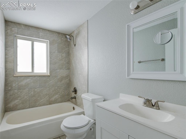 full bathroom featuring tiled shower / bath, vanity, and toilet