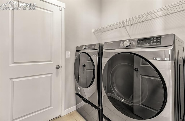 washroom with independent washer and dryer and light tile patterned flooring