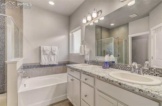 bathroom with independent shower and bath, vanity, and tile patterned flooring