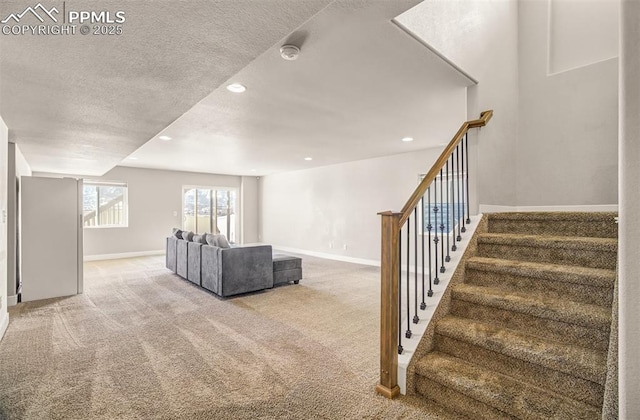 unfurnished living room featuring light carpet and a textured ceiling