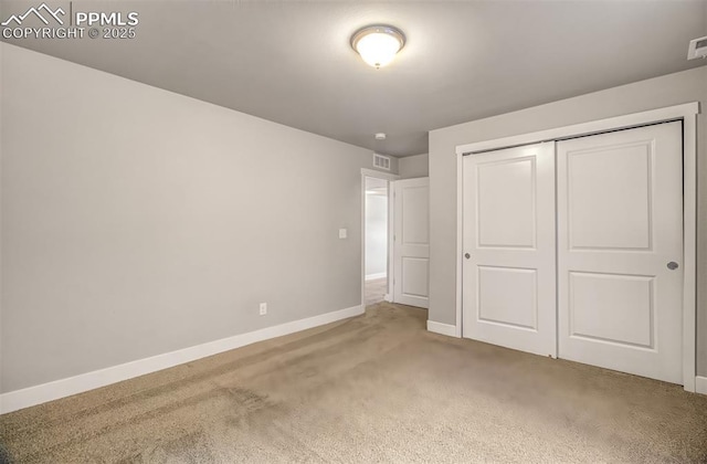 unfurnished bedroom with carpet floors and a closet