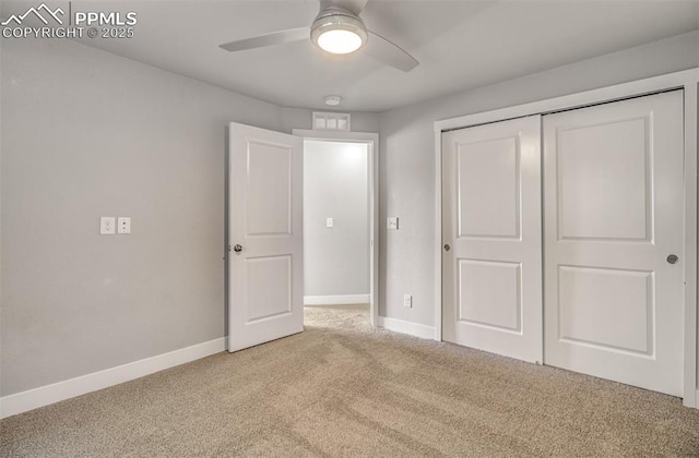 unfurnished bedroom with light colored carpet, ceiling fan, and a closet