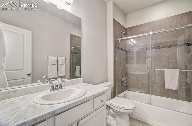 full bathroom featuring vanity, toilet, tile patterned flooring, and combined bath / shower with glass door