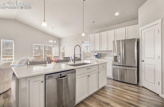 kitchen with a kitchen island with sink, sink, white cabinetry, and stainless steel appliances