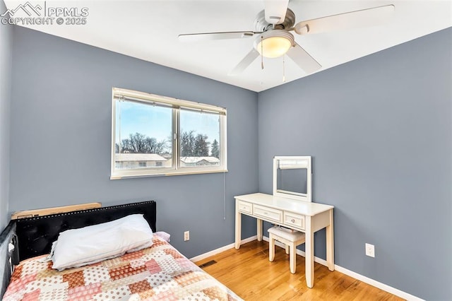 bedroom featuring hardwood / wood-style floors and ceiling fan