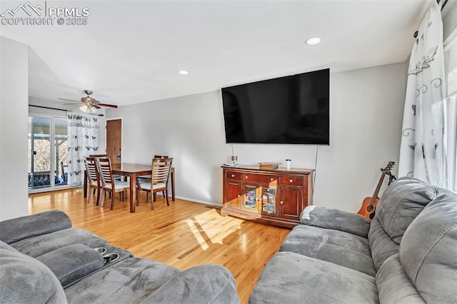 living room with hardwood / wood-style flooring and ceiling fan