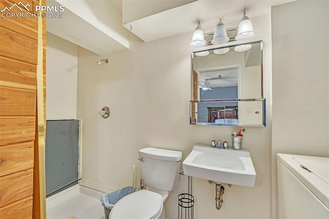 bathroom featuring a shower, sink, and toilet