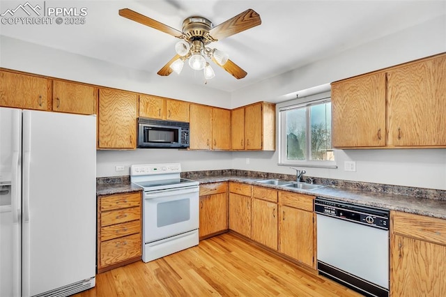 kitchen featuring ceiling fan, white appliances, sink, and light hardwood / wood-style flooring