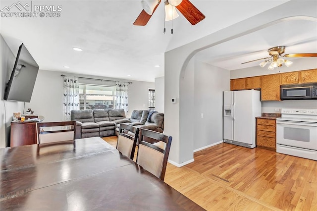 kitchen featuring stainless steel counters, white appliances, light hardwood / wood-style flooring, and ceiling fan