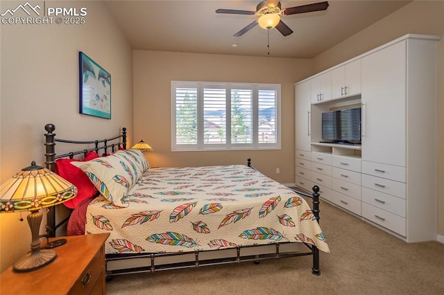 bedroom featuring ceiling fan and carpet