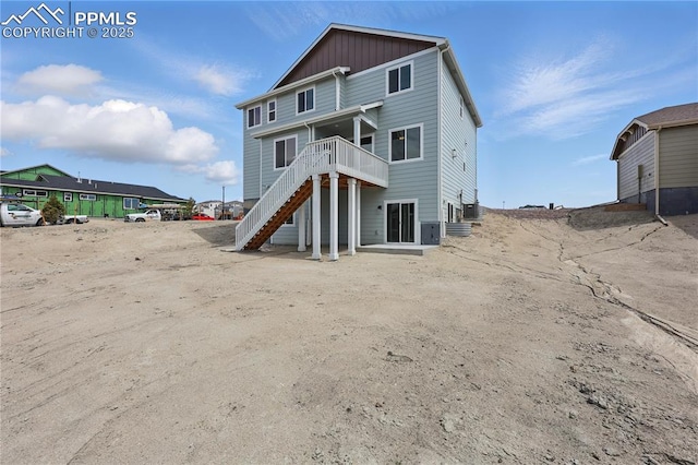 16896 Greenfield Dr, Monument, CO 80132 - back of house featuring a wooden deck, stairway, board and batten siding, and central air condition unit