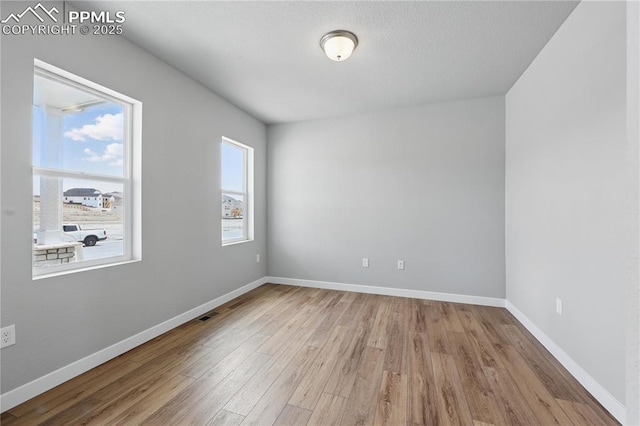 16896 Greenfield Dr, Monument, CO 80132 - empty room featuring visible vents, wood finished floors, and baseboards
