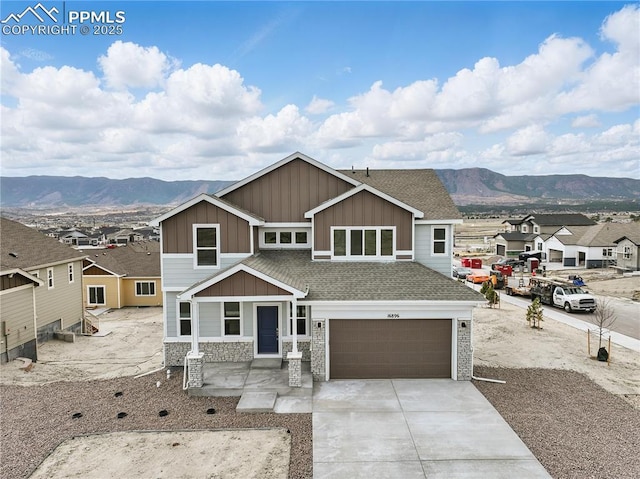 16896 Greenfield Dr, Monument, CO 80132 - craftsman-style house featuring a garage, a mountain view, board and batten siding, and stone siding