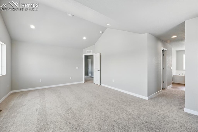 16896 Greenfield Dr, Monument, CO 80132 - spare room featuring light colored carpet, recessed lighting, vaulted ceiling, and baseboards