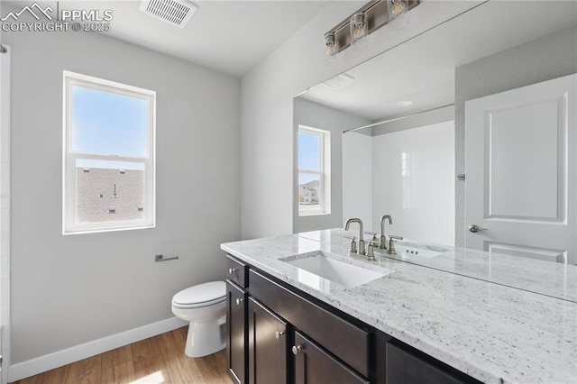 16896 Greenfield Dr, Monument, CO 80132 - full bathroom with toilet, visible vents, baseboards, walk in shower, and wood finished floors