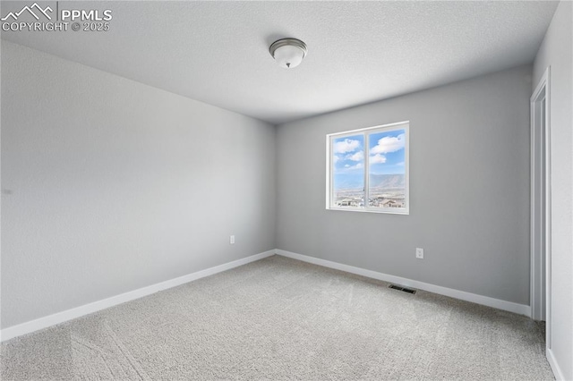 16896 Greenfield Dr, Monument, CO 80132 - unfurnished room with a textured ceiling, visible vents, baseboards, and carpet floors