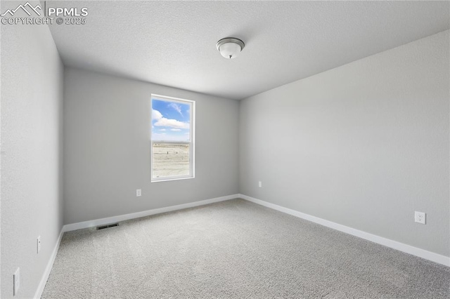 16896 Greenfield Dr, Monument, CO 80132 - carpeted empty room with baseboards, visible vents, and a textured ceiling