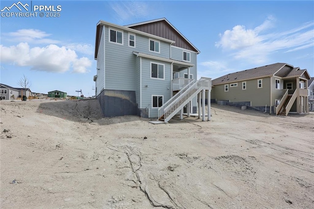 16896 Greenfield Dr, Monument, CO 80132 - back of house featuring stairway and board and batten siding