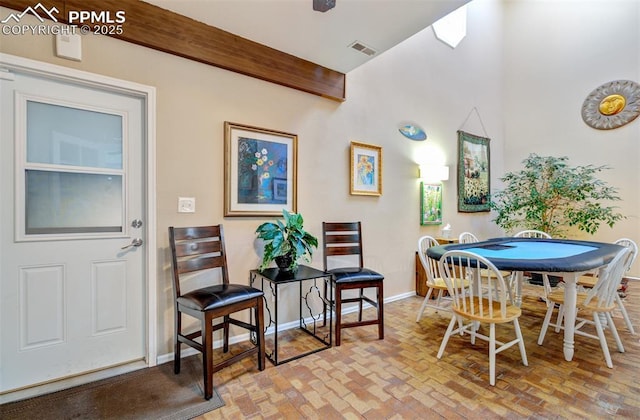 dining area featuring beam ceiling