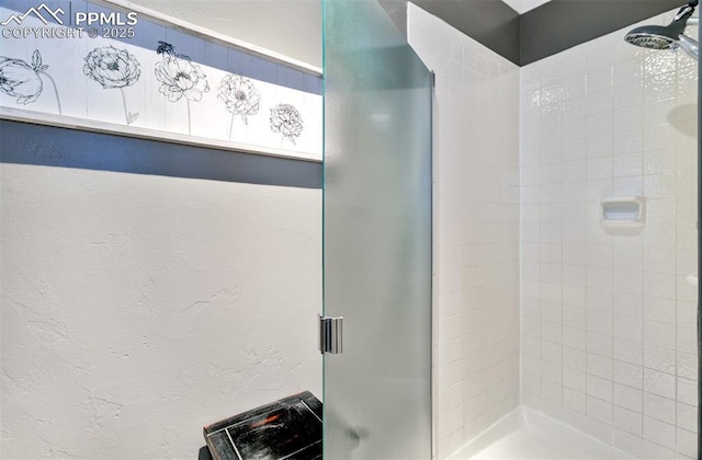 bathroom with a shower with shower door