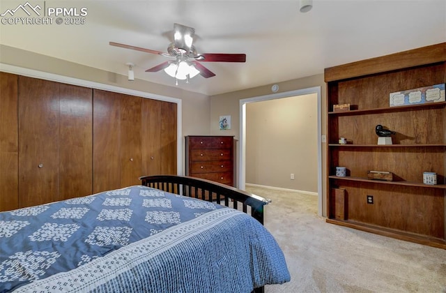 carpeted bedroom with ceiling fan and a closet