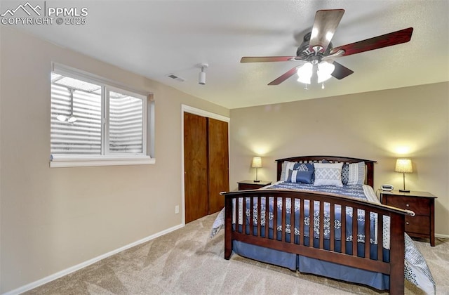 bedroom with light carpet, a closet, and ceiling fan