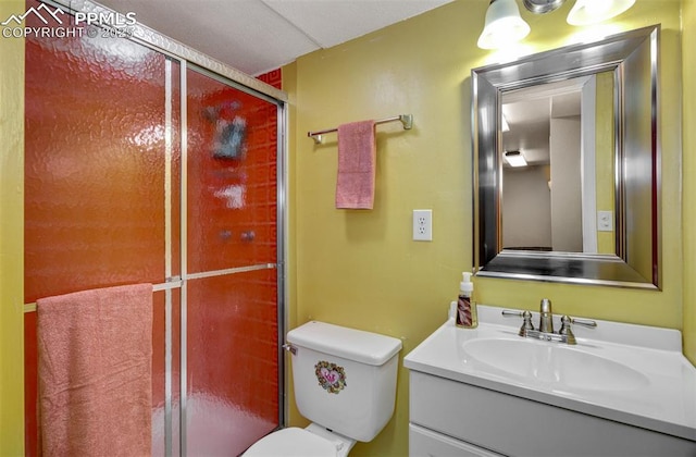 bathroom featuring vanity, toilet, and an enclosed shower