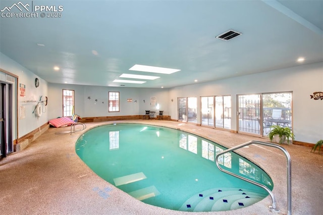 view of swimming pool with a skylight