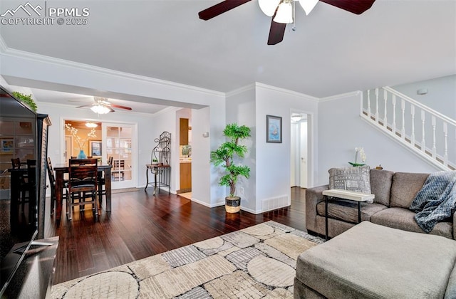 living room featuring ceiling fan, crown molding, and dark hardwood / wood-style flooring