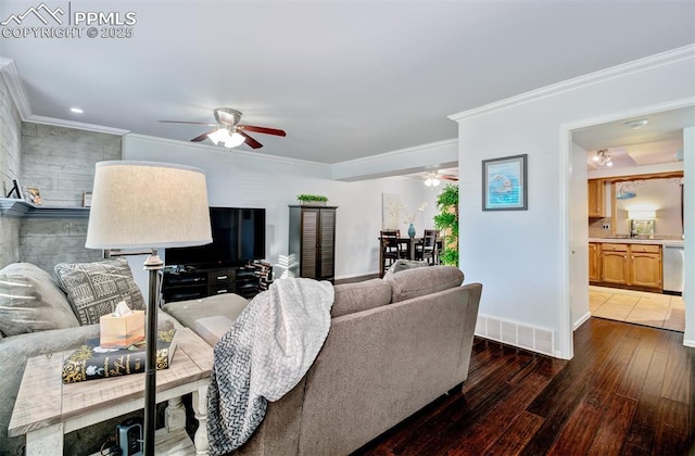 living room with sink, ceiling fan, crown molding, and dark wood-type flooring