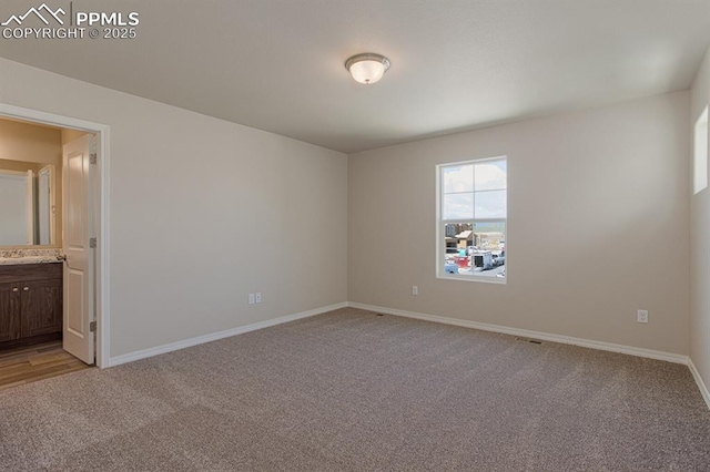 unfurnished room with light carpet