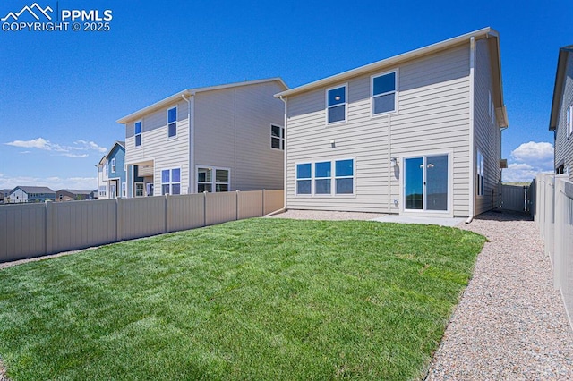 rear view of property featuring a lawn